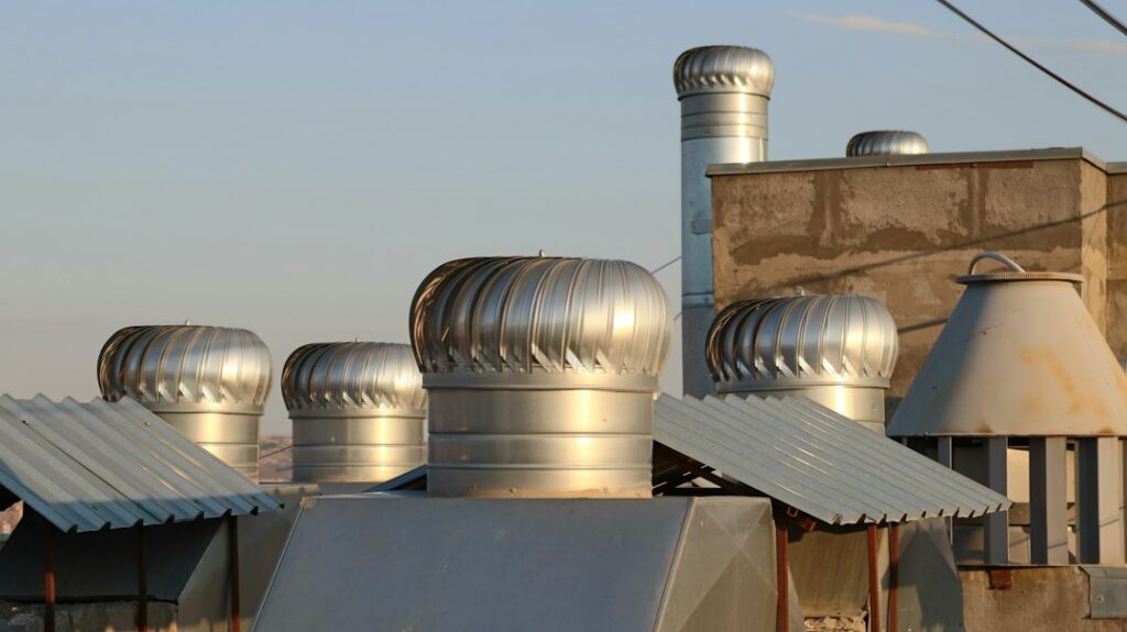 stainless steel chimney cap on a residential roof